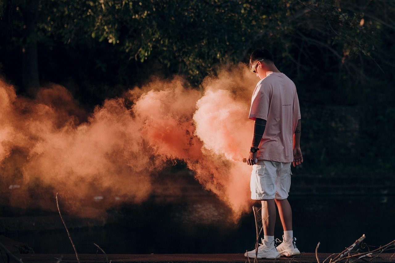 Model in an oversized tee standing in smoke on a city street, wearing the FORME STUDIO everyday collection